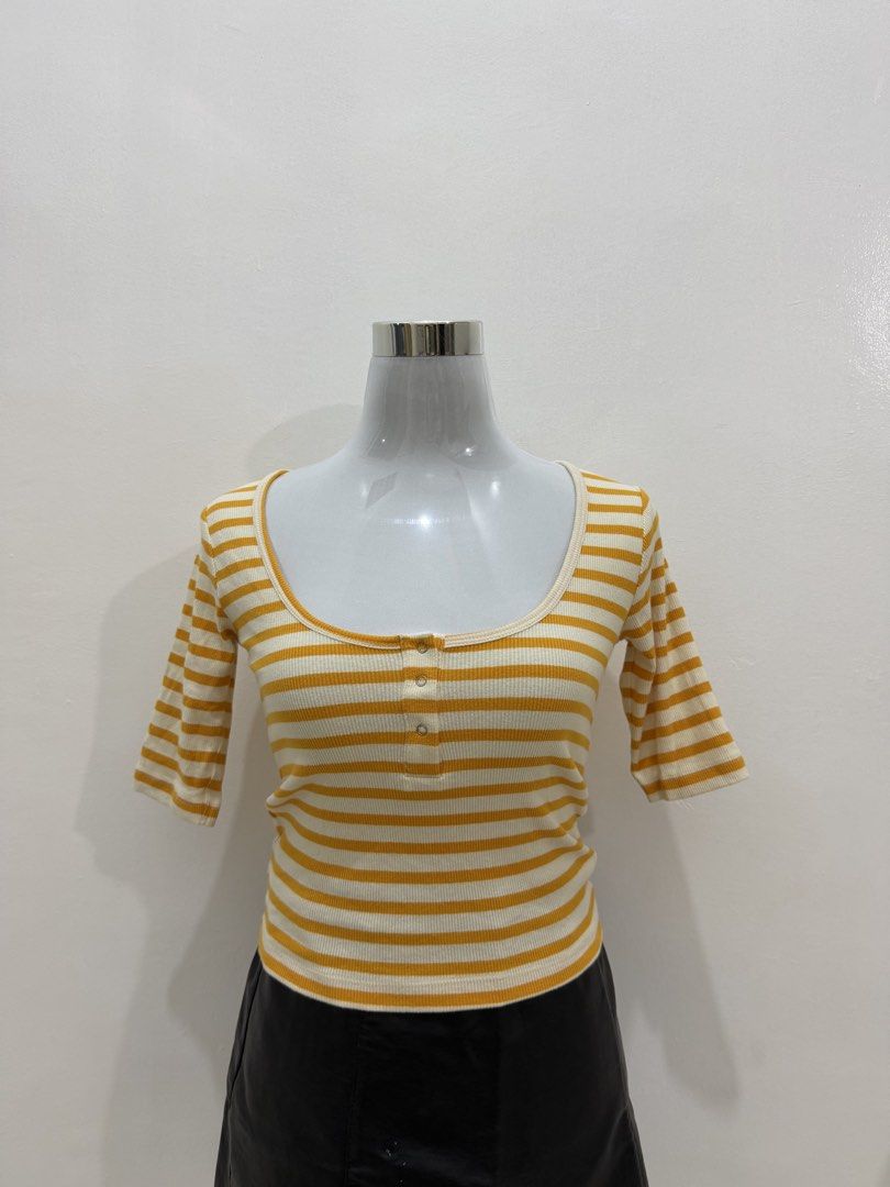 Yellow and White Striped Ribbed Henley Top (Category: Blouses) located in Manila. Submitted by e.louise (Listing ID 1464334775, Image 1). Description: - Cute ribbed top with yellow and white stripes - Features a scoop neckline and short sleeves - Button-up detail at the front - Versatile for pairing with jeans or skirts - Comfortable and stylish for everyday wear.