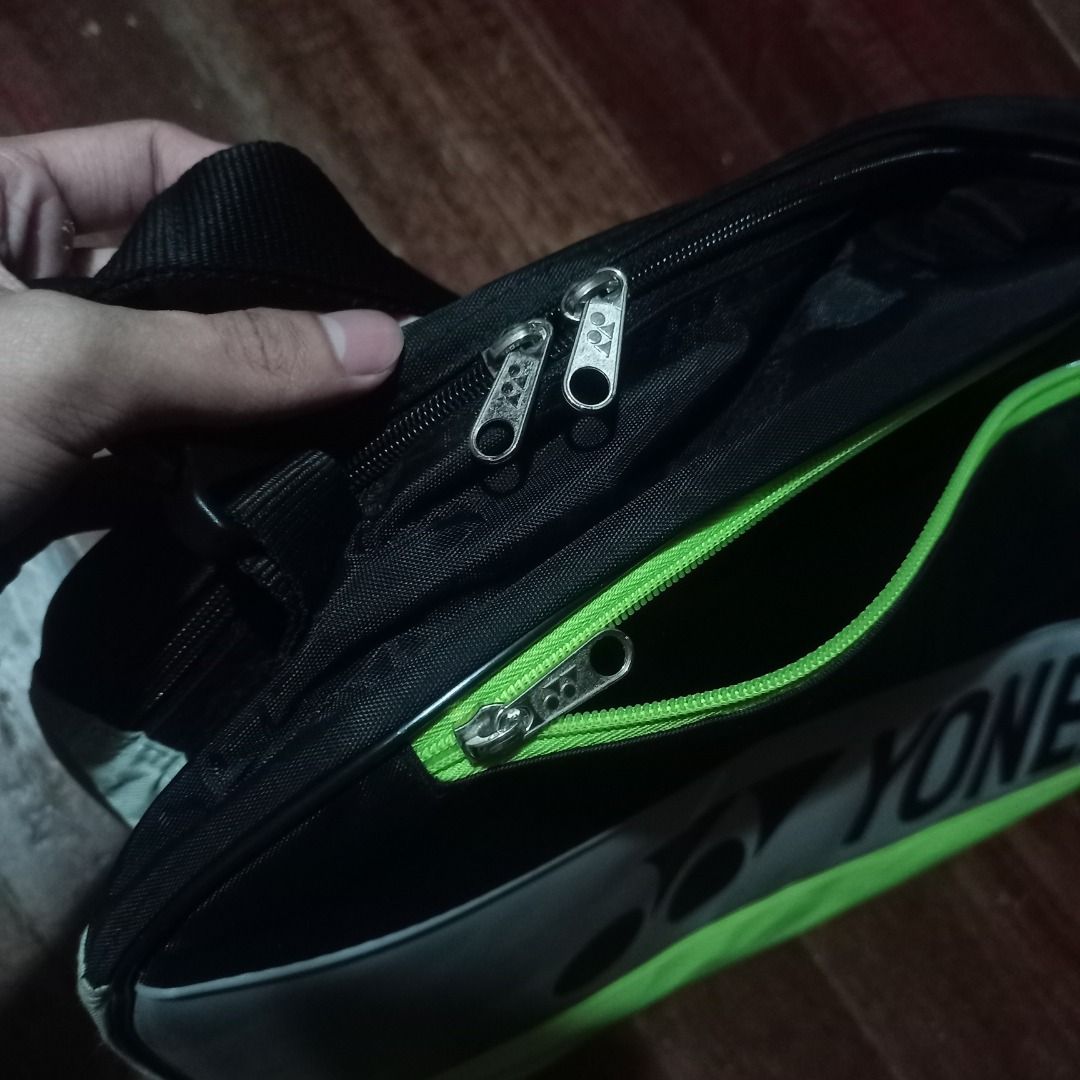 Yonex Badminton Bag (Category: Racket and Ball Sports) located in Cavite. Submitted by kurtgg.what (Listing ID 1464243146, Image 3). Description: Great condition!! though may stains lang, removable naman, labahan nyo nalang lalamove courier po ang pref kasi pag sa j&t baka masira po sya if tinupi. - Black and lime green Yonex bag - Multiple zippered compartments for storage - Adjustable shoulder strap - Ideal for badminton rackets and accessories