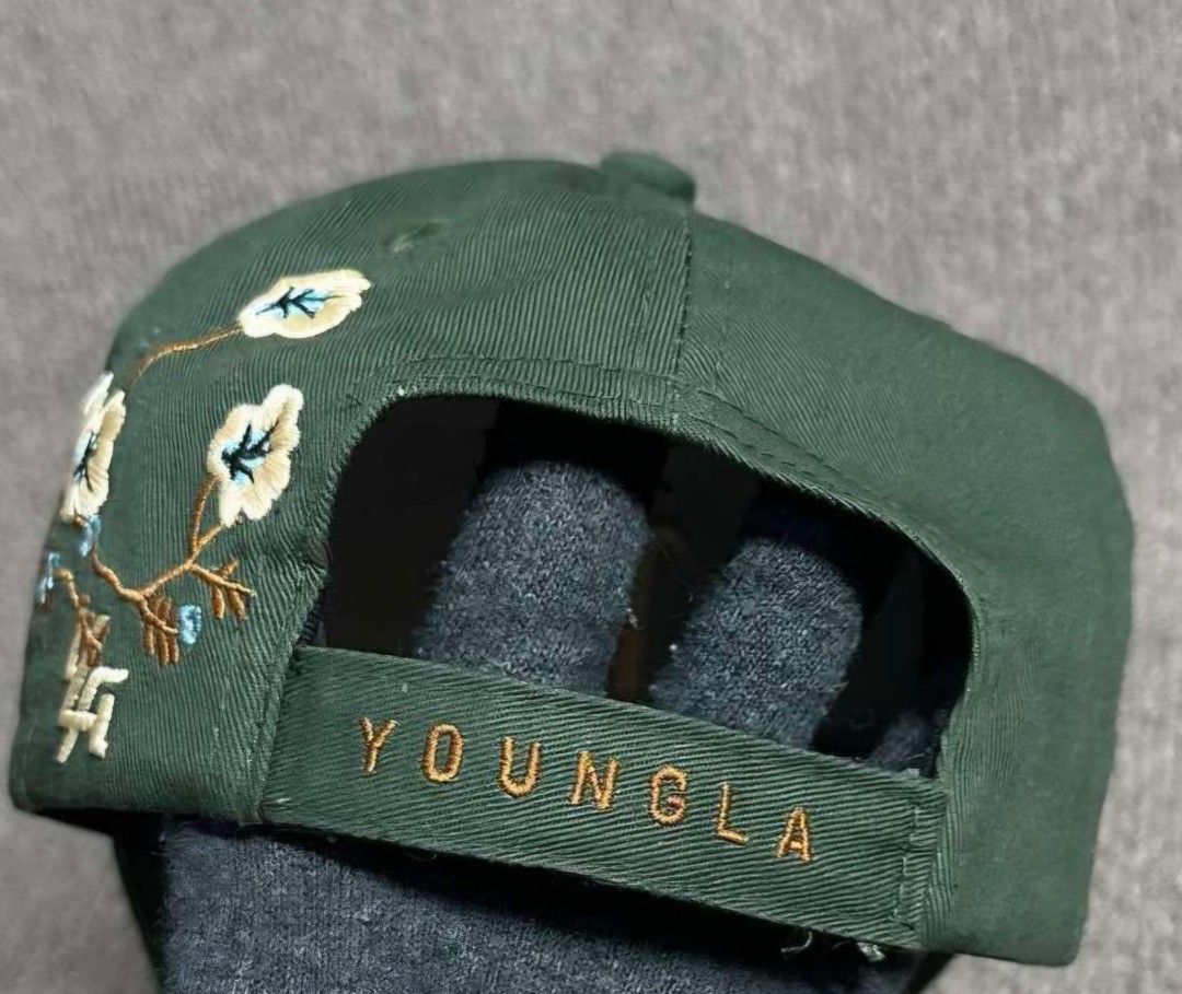 YOUNGLA Cap with Floral Embroidery (Category: Caps & Hats) located in La Trinidad. Submitted by odin21 (Listing ID 1464222079, Image 3). Description: - Color: Cool Green - Front Embroidery: 'LA' - Side Design: Floral with blue accents - Back Embroidery: 'YOUNGLA' - Condition: Shows some signs of wear, still looks good - Style: Great for casual wear.