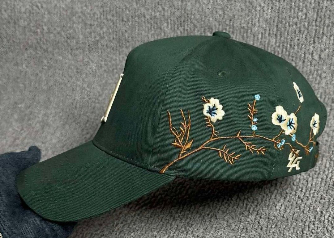 YOUNGLA Cap with Floral Embroidery (Category: Caps & Hats) located in La Trinidad. Submitted by odin21 (Listing ID 1464222079, Image 2). Description: - Color: Cool Green - Front Embroidery: 'LA' - Side Design: Floral with blue accents - Back Embroidery: 'YOUNGLA' - Condition: Shows some signs of wear, still looks good - Style: Great for casual wear.