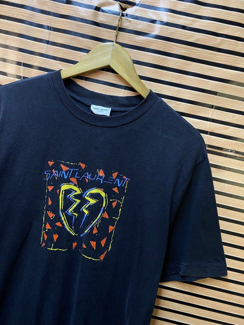 YSL “Broken Heart Jaguard” Tee (Category: Tshirts & Polo Shirts ) located in Makati City. Submitted by drip.poww (Listing ID 1464235857, Image 2). Description: - Authentic YSL - Color: Black - Size: Large - Dimes: 23x28 - Authentic - Excellent condition - Need wash, fresh from bale - Material: 100% Cotton Please don’t expect too much—these are thrifted (ukay) items. 😊 !!STILL NEGOTIABLE!!.