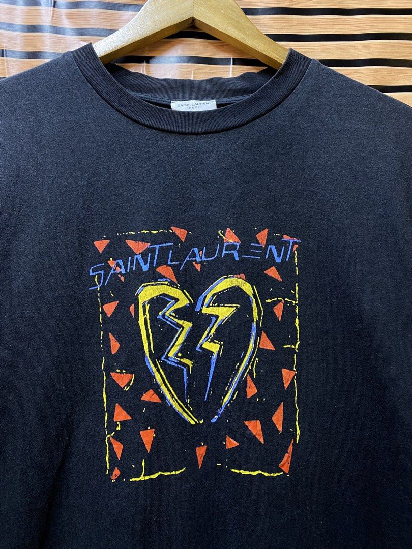 YSL “Broken Heart Jaguard” Tee (Category: Tshirts & Polo Shirts ) located in Makati City. Submitted by drip.poww (Listing ID 1464235857, Image 3). Description: - Authentic YSL - Color: Black - Size: Large - Dimes: 23x28 - Authentic - Excellent condition - Need wash, fresh from bale - Material: 100% Cotton Please don’t expect too much—these are thrifted (ukay) items. 😊 !!STILL NEGOTIABLE!!.