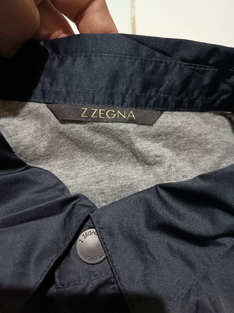 Z Zegna Navy Coach Jacket XL (Category: Coats, Jackets and Outerwear) located in Barotac Nuevo. Submitted by gray101 (Listing ID 1464243390, Image 3). Description: - Navy blue Z Zegna coach jacket - Size XL - Snap button closure - Drawstring hem - Made in Romania - Ideal for layering - Please check photos for detailed condition.