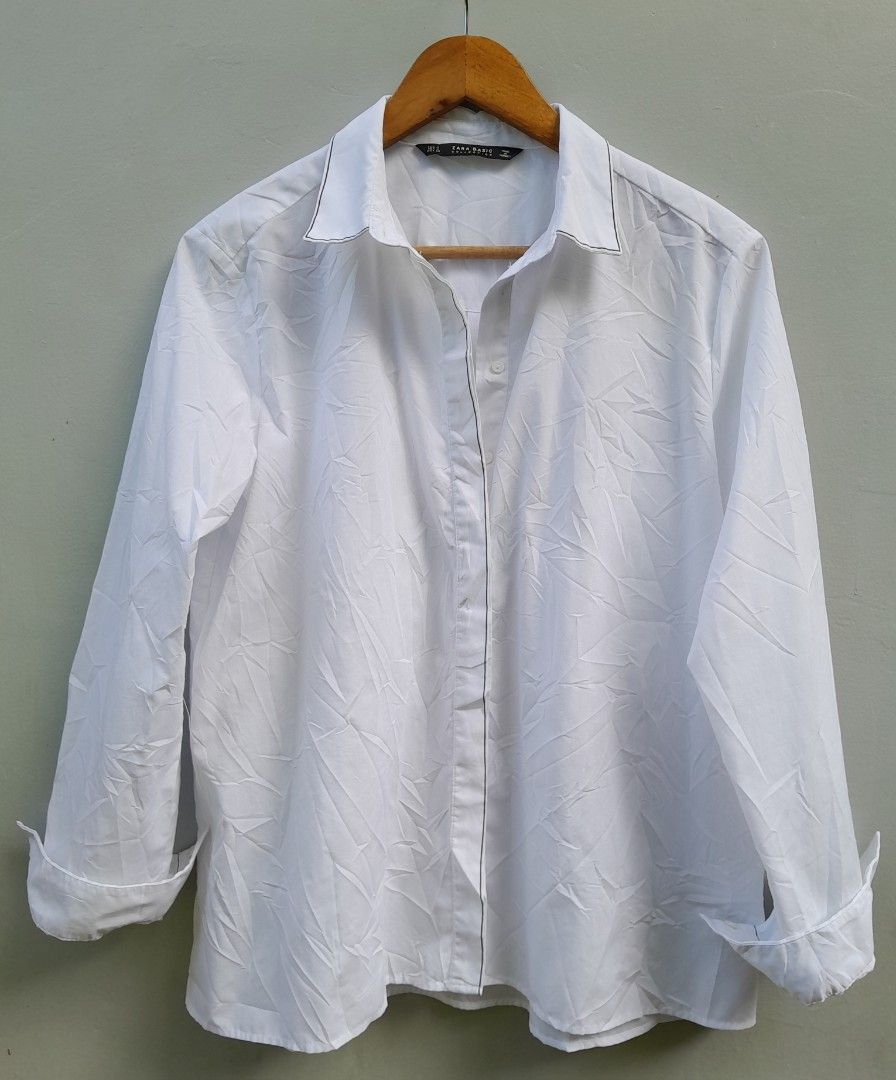 Zara Basic White Long Sleeve Shirt with Black Piping (Category: Longsleeves) located in Davao. Submitted by parenasnic86577 (Listing ID 1464185072, Image 1). Description: - White Zara Basic shirt - Long sleeves with cuffs - Subtle black piping along collar and button placket - Relaxed fit - Versatile for casual and smart-casual styling.