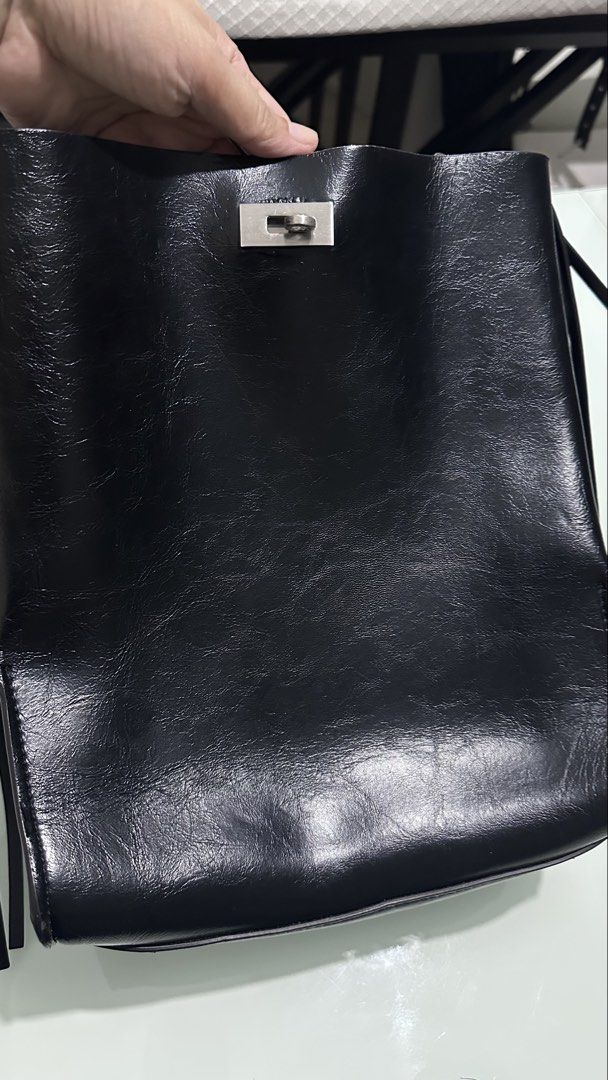 Zara Black Leather Shoulder Bag with Studded Strap (Category: Shoulder Bags) located in Mandaluyong City. Submitted by TheWeekendProject (Listing ID 1461518827, Image 3). Description: - Cool black leather shoulder bag - Unique studded chain strap - Includes a thinner strap - Fringed details on the sides - Silver hardware closure - Ideal for night outs or adding an edgy touch to any outfit - Minor signs of use inside but still clean - Outside is g