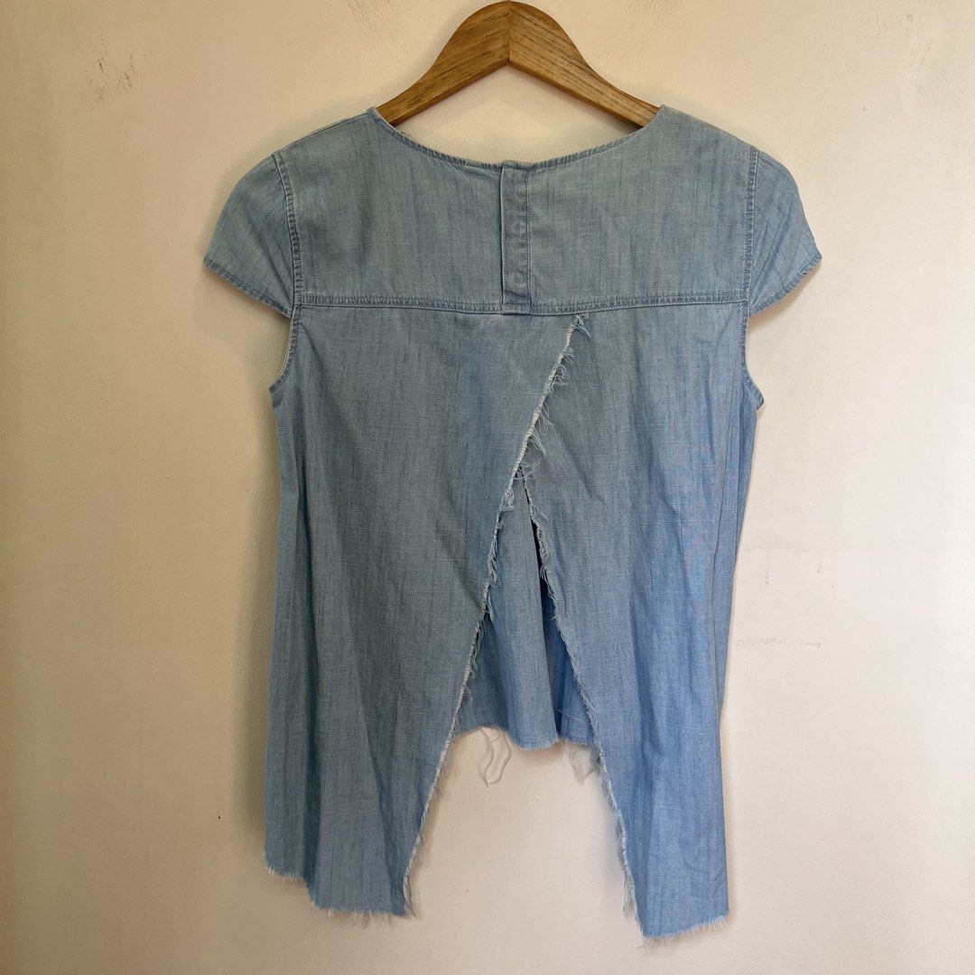 Zara Denim Chambray Split Back Top (Category: Sleeveless) located in Makati City. Submitted by moneybunny (Listing ID 1464154459, Image 3). Description: - Light wash denim top - Authentic Zara - Round neckline - Split back detail - Raw hem on bottom - Small front pocket -Flaw: discoloration or fading but not super obvious (see last pic) .