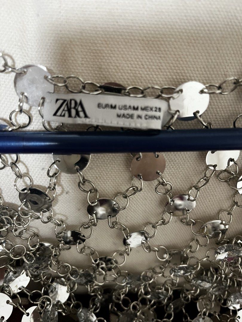 Zara Silver Chainmail Top (Category: Sleeveless) located in Manila. Submitted by lorenasant37621 (Listing ID 1464215768, Image 2). Description: - Sparkly silver chainmail top from Zara - Features many small circular metals linked together - Ideal for parties or festivals - Adds significant shine to any outfit - Unique and eye-catching piece.