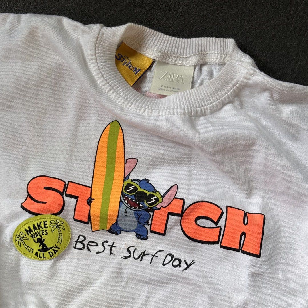ZARA Stitch T-shirt (2 Years) (Category: Babies & Kids Fashion) located in Mati. Submitted by sharieeng (Listing ID 1464145737, Image 3). Description: - Soft cotton white t-shirt - Features Stitch and Lilo graphics - Front design: 'Stitch Best Surf Day' - Back design: 'Lilo & Stitch Hawaii Best Surf Day' - Ideal for fans of Lilo & Stitch.