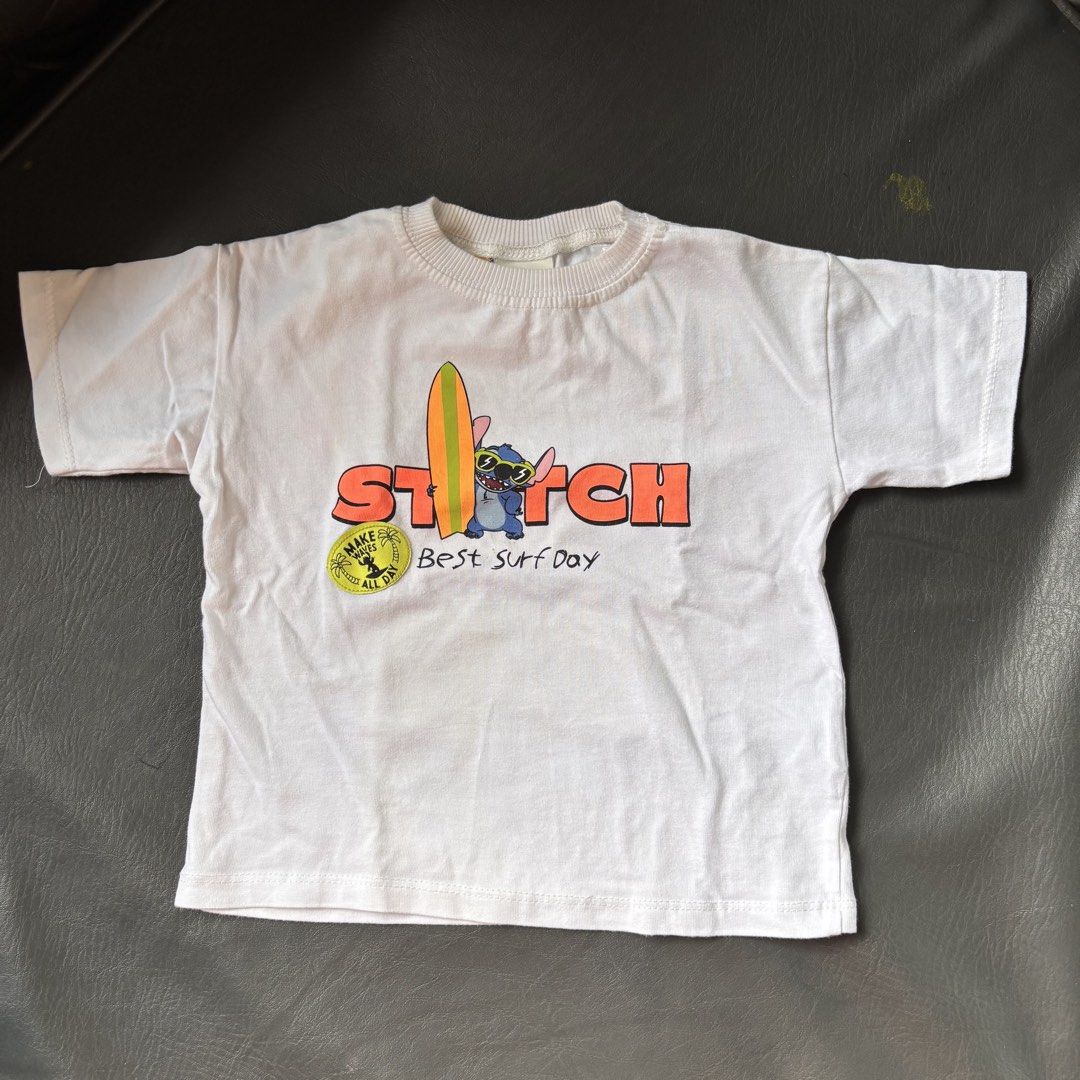 ZARA Stitch T-shirt (2 Years) (Category: Babies & Kids Fashion) located in Mati. Submitted by sharieeng (Listing ID 1464145737, Image 1). Description: - Soft cotton white t-shirt - Features Stitch and Lilo graphics - Front design: 'Stitch Best Surf Day' - Back design: 'Lilo & Stitch Hawaii Best Surf Day' - Ideal for fans of Lilo & Stitch.