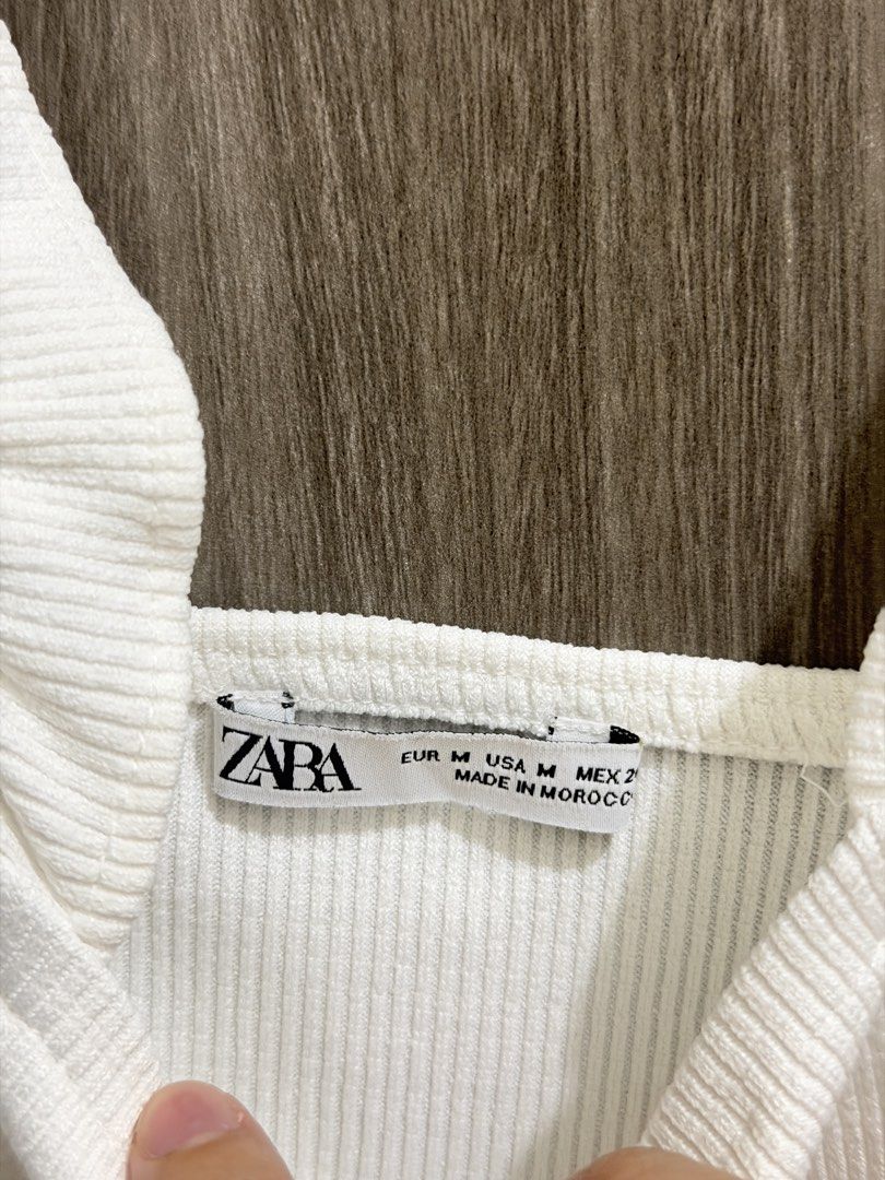 Zara White Ribbed Ruffle Strap Crop Top Size M (Category: Sleeveless) located in Manila. Submitted by ktyyycloset (Listing ID 1464248348, Image 2). Description: - White ribbed crop top from Zara - Features cute ruffle straps - Square neckline - Versatile: pairs well with jeans or skirts - Ideal for casual outings or nights with friends - Size: Medium.
