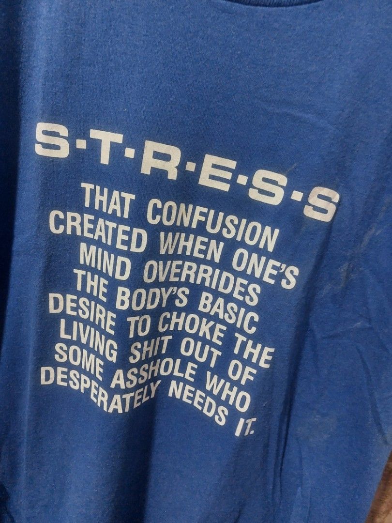 80s Jerzees "STRESS" Graphic T-Shirt (Category: Tshirts & Polo Shirts ) located in Magarao. Submitted by hotdogsandwich.flower (Listing ID 1464384970, Image 2). Description: - Brand: Jerzees - Color: Blue - Graphic Print: Spells 'STRESS' with definition - Material: 50% Cotton, 50% Polyester - Size: Medium (M) - Condition: Faint marks on the front (please check photos for details).