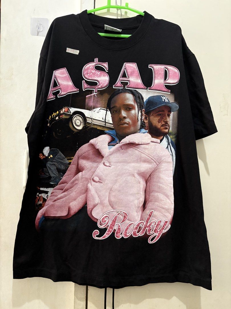 A$AP Rocky Graphic T-Shirt (Category: Tshirts & Polo Shirts ) located in Manila. Submitted by dominicoab75406 (Listing ID 1464373372, Image 1). Description: - Black t-shirt with A$AP Rocky graphics - Large A$AP Rocky print on front with "A$AP" and "Rocky" text - Multiple A$AP Rocky images on the back - Made from comfortable fabric - Ideal for A$AP Rocky fans.