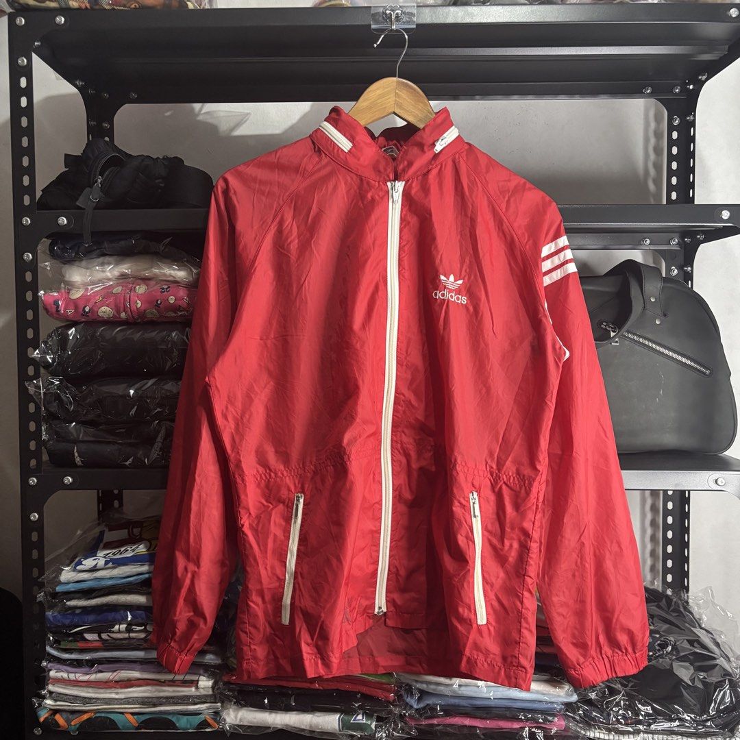 Adidas - Red Windbreaker Jacket with White Accents (Category: Coats, Jackets and Outerwear) located in Cavite. Submitted by goodstayojan.cvt (Listing ID 1464414461, Image 1). Description: Vintage Adidas - Foldable Hooded Nylon Jacket M on tag(20 x 25.5) Verygood Condition No flaws! - Red Adidas windbreaker jacket - White zipper and sleeve accents - 100% Nylon material - Made by Descente under Adidas license Negotiable! Kindly dm for your offer! D