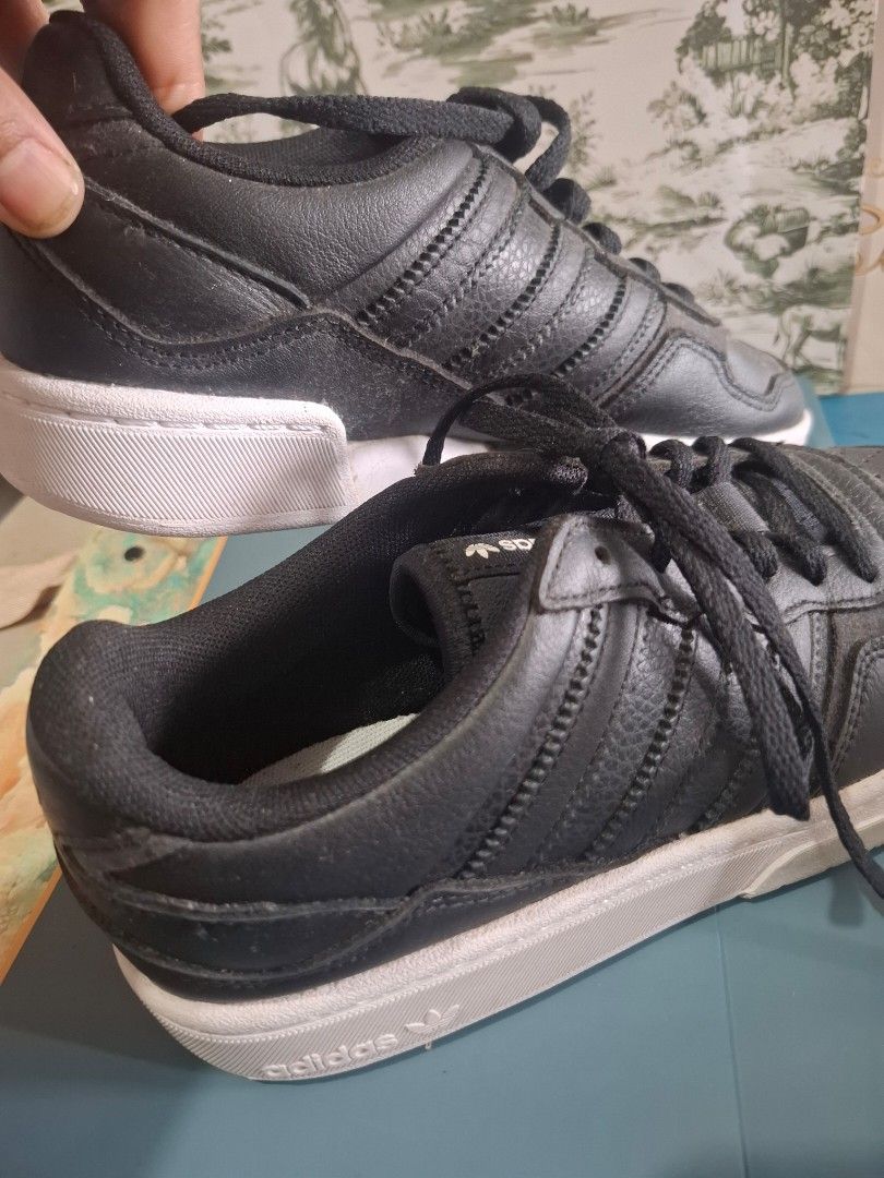 Adidas Black Sneakers (Category: Sneakers) located in Marikina City. Submitted by bags21.ph (Listing ID 1464373159, Image 2). Description: - Classic black Adidas sneakers - Iconic three-stripe design - Perforated toe box for breathability - Secure lace-up closure - Clean white sole - Ideal for casual outings and everyday wear.