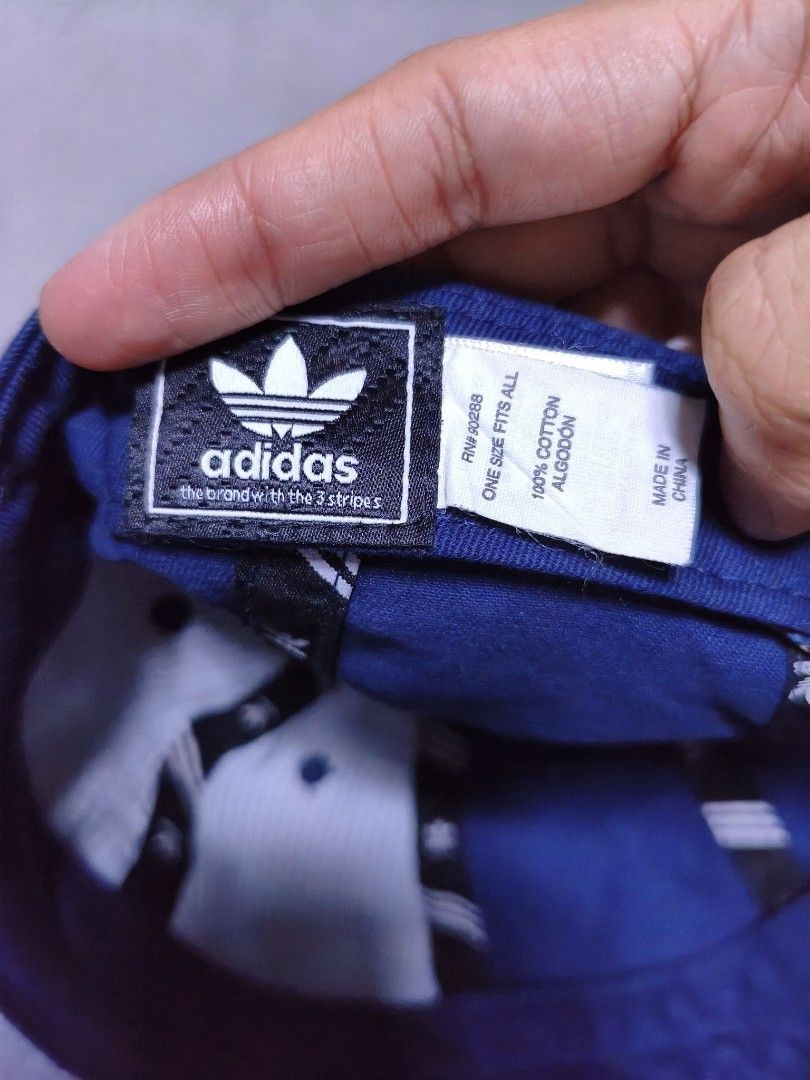 Adidas Cap Blue Trefoil Logo Cap (Category: Caps & Hats) located in Malilipot. Submitted by aronbigorn96320 (Listing ID 1464489509, Image 3). Description: - Classic Adidas cap in a nice blue color. - Features the iconic trefoil logo embroidered on the front. - Adjustable strap at the back for a comfortable fit. - Made from 100% cotton. - Great for everyday wear. - Womens or youth size.