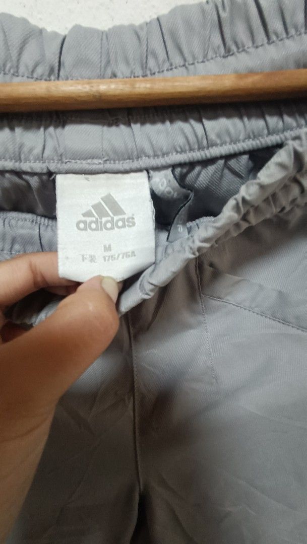 Adidas Grey Track Pants (Category: Joggers) located in Manila. Submitted by princess_1118 (Listing ID 1464400763, Image 2). Description: - Grey Adidas track pants - Size: Medium (M) - Elastic waistband with adjustable drawstring - Iconic three stripes down the sides - Adjustable drawstring at the ankles - Versatile for casual wear or sports activities.