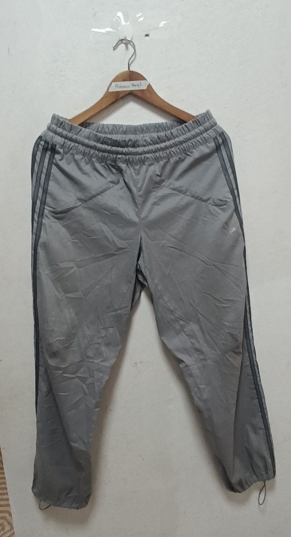Adidas Grey Track Pants (Category: Joggers) located in Manila. Submitted by princess_1118 (Listing ID 1464400763, Image 1). Description: - Grey Adidas track pants - Size: Medium (M) - Elastic waistband with adjustable drawstring - Iconic three stripes down the sides - Adjustable drawstring at the ankles - Versatile for casual wear or sports activities.