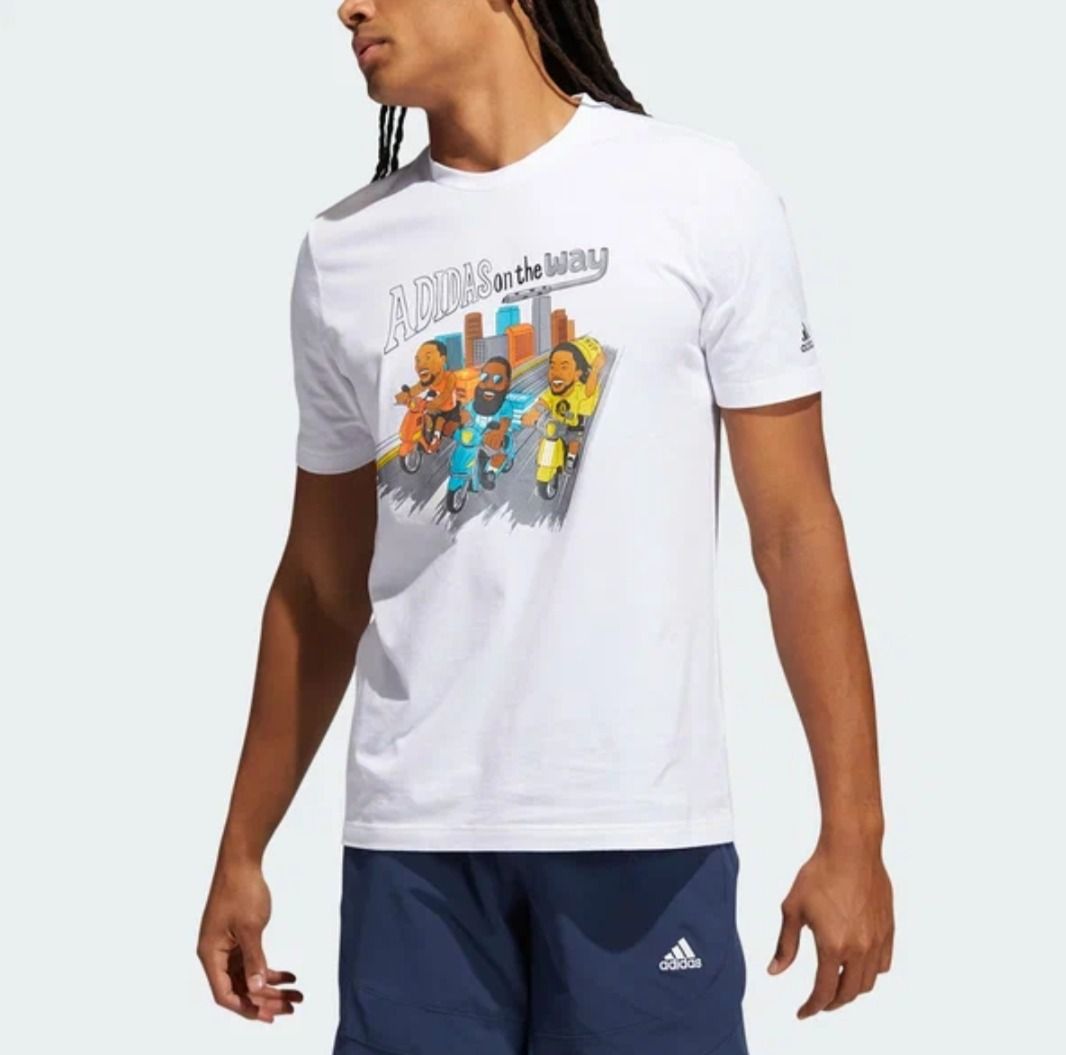Adidas "On The Way" Graphic Tee White (Category: Tshirts & Polo Shirts ) located in Caloocan City. Submitted by eragamisch70090 (Listing ID 1464522484, Image 3). Description: - White Adidas T-shirt - Fun graphic print on front: cartoon characters riding scooters in a city - Adidas logo detail on sleeve - Ideal for casual and everyday wear.