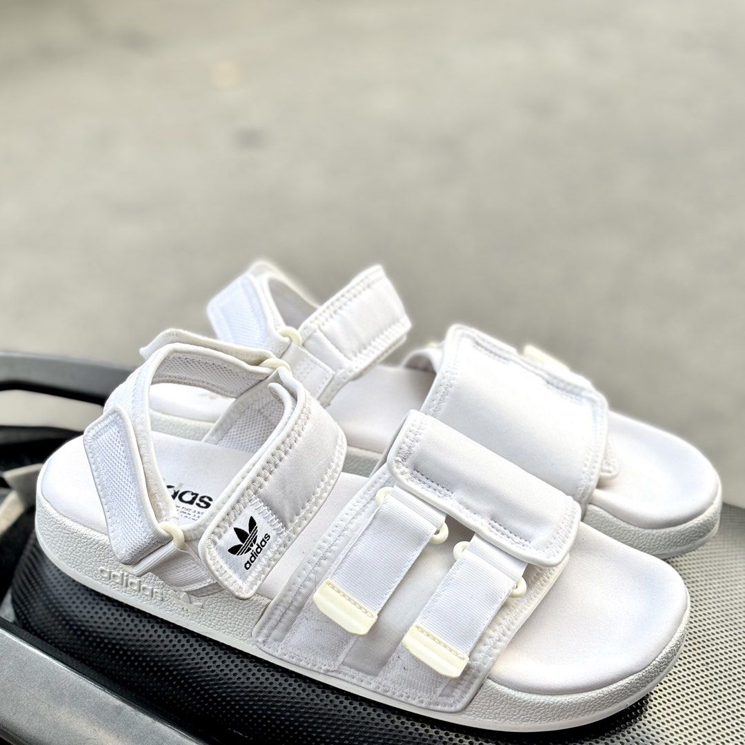 Adidas White Men's Sandals Size 10 (Category: Slippers & Slides) located in San Fernando. Submitted by kickslocker (Listing ID 1464369599, Image 2). Description: - White Adidas slides for men - Size 10 (28.5cm) - Adjustable straps for a comfortable fit - Ideal for casual outings or beach days - Comfortable and stylish.