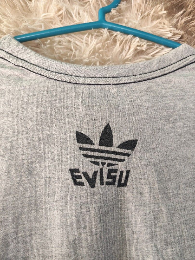 Adidas x Evisu Collaboration T-Shirt (Category: Tshirts & Polo Shirts ) located in Rizal, Mindoro Occidental. Submitted by finding_ukaygems5103 (Listing ID 1464476088, Image 3). Description: - Authentic Adidas x Evisu collaboration grey t-shirt. - Features the classic Adidas trefoil logo on the front. - Distinctive Evisu branding on the back. - Proudly made in Japan. - A must-have item for collectors. - Ideal for everyday casual wear. - Check out