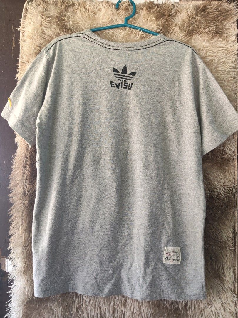 Adidas x Evisu Collaboration T-Shirt (Category: Tshirts & Polo Shirts ) located in Rizal, Mindoro Occidental. Submitted by finding_ukaygems5103 (Listing ID 1464476088, Image 2). Description: - Authentic Adidas x Evisu collaboration grey t-shirt. - Features the classic Adidas trefoil logo on the front. - Distinctive Evisu branding on the back. - Proudly made in Japan. - A must-have item for collectors. - Ideal for everyday casual wear. - Check out