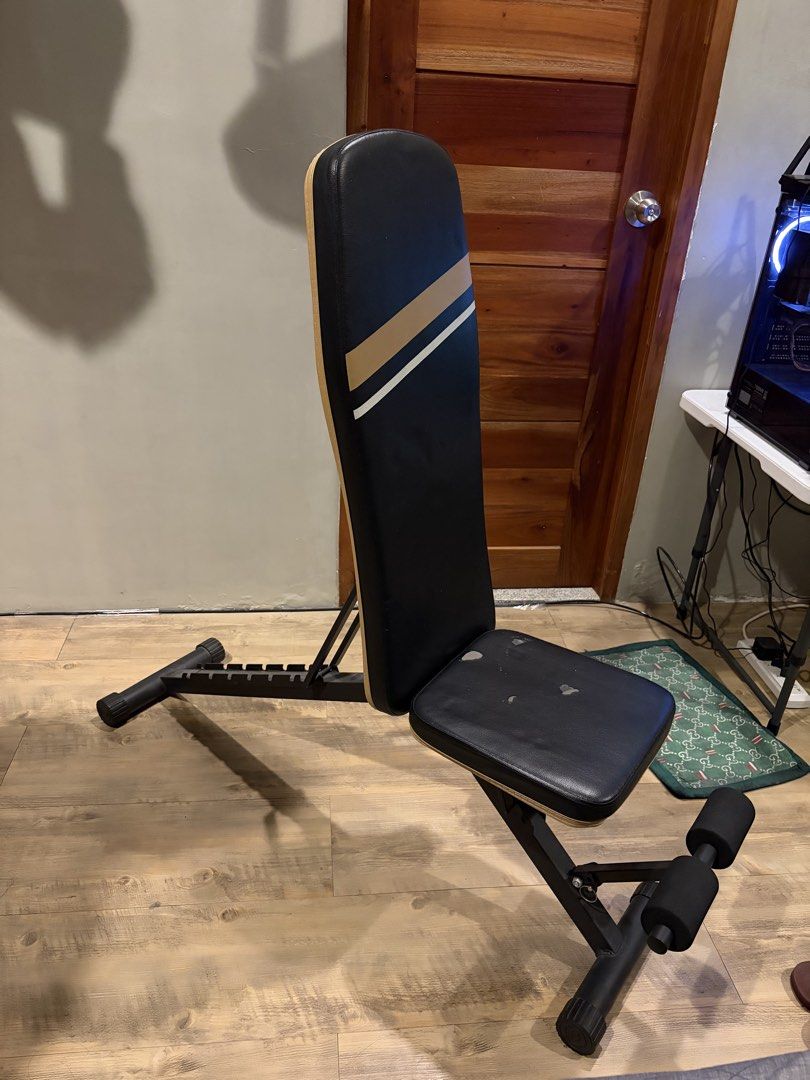 Adjustable Weight Bench for Home Gym Workouts (Category: Weights & Dumbbells) located in Quezon City. Submitted by badussy (Listing ID 1464540126, Image 1). Description: - Versatile weight bench for your home gym - Easily adjustable backrest and seat for various exercises - Padded foam rollers for comfortable leg workouts - Sturdy metal frame for durability - Folds for convenient storage - Ideal for strength training and fitness routines.