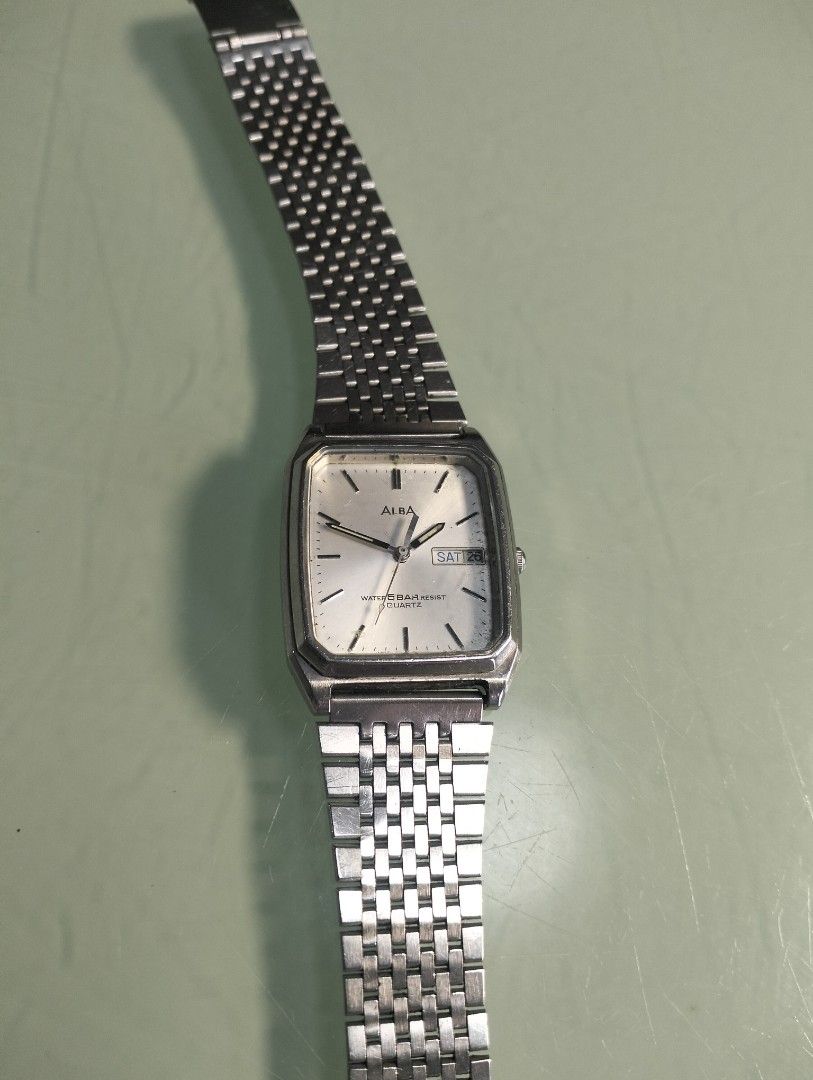 Alba Quartz Watch Water Resist Day Date (Category: Men's Watches) located in General Mariano Alvarez. Submitted by ma.miafajardo1219 (Listing ID 1464421807, Image 1). Description: - Alba Quartz Watch - Silver-tone casing and metal strap - White dial with day and date display - Water resistant 5 bar - Fully functional, works well - Minor cosmetic scratches on watch face and casing tank type with new battery .