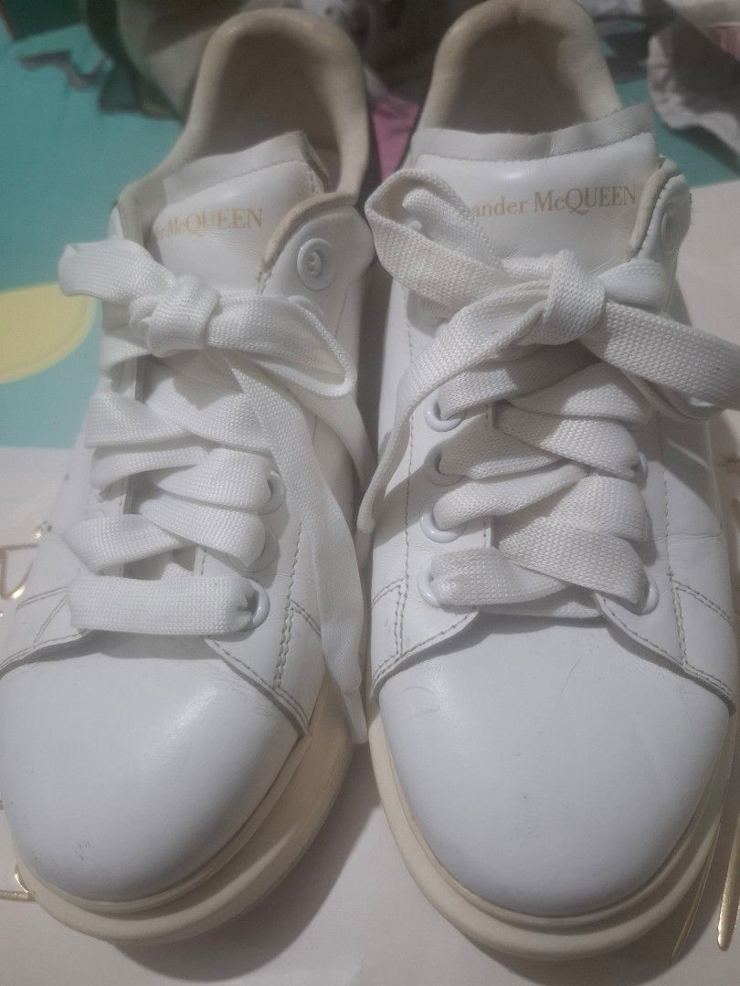 Alexander McQueen Oversized Sneakers White Leather (Category: Sneakers) located in Marikina City. Submitted by bags21.ph (Listing ID 1464483014, Image 1). Description: - Authentic Alexander McQueen sneakers - Classic oversized sole style - White leather upper and laces - Gold logo detail on heel tab - Size: 36 - Condition: Minor scuffs on sole from normal wear, upper is clean - Perfect statement piece for any outfit.