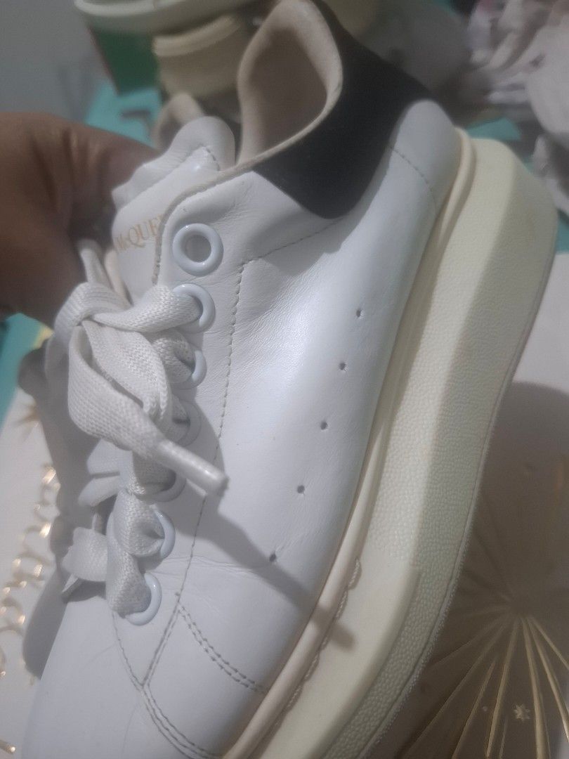 Alexander McQueen Oversized Sneakers White Leather (Category: Sneakers) located in Marikina City. Submitted by bags21.ph (Listing ID 1464483014, Image 2). Description: - Authentic Alexander McQueen sneakers - Classic oversized sole style - White leather upper and laces - Gold logo detail on heel tab - Size: 36 - Condition: Minor scuffs on sole from normal wear, upper is clean - Perfect statement piece for any outfit.