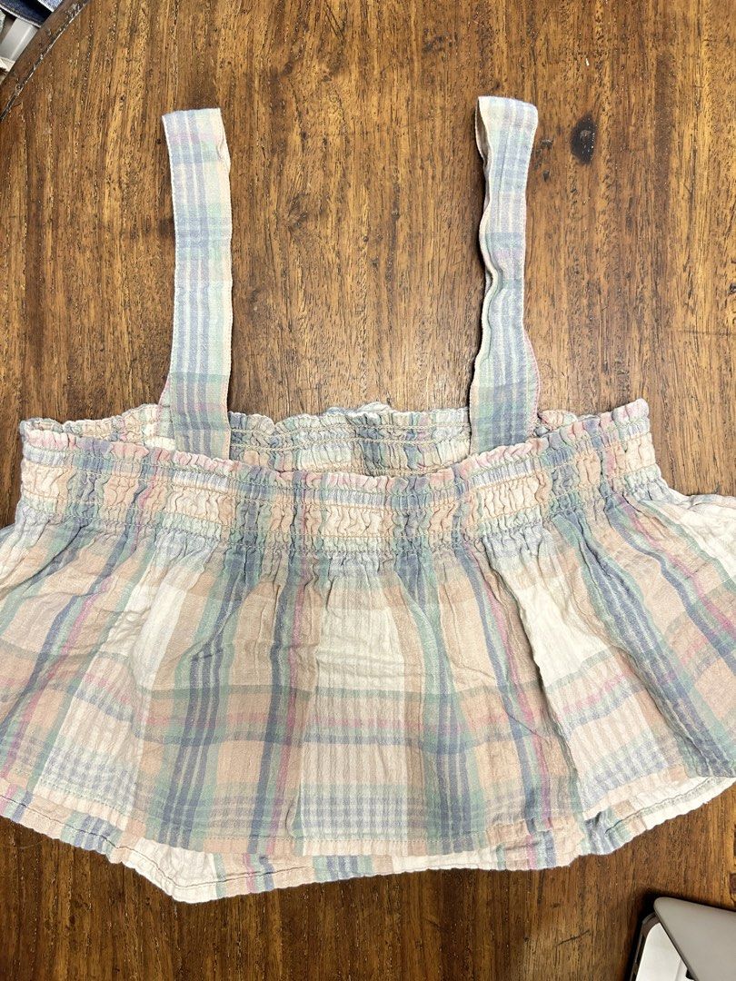 American Eagle Pastel Plaid Crop Top (Category: Sleeveless) located in Antipolo. Submitted by tshopph (Listing ID 1464456372, Image 2). Description: American Eagle Pastel Plaid Smocked Crop Top 💕 Features a stretchy smocked bust, a cute front tie detail, comfortable thick shoulder straps, and a relaxed peplum/babydoll hem. Made from lightweight, breathable crinkle cotton—super easy to style with high-waisted jeans, denim shorts, or skirts Condit