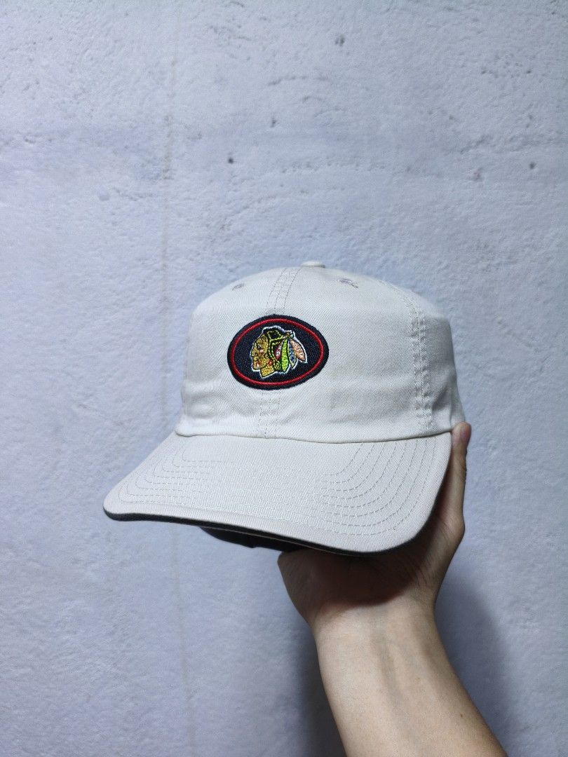 American Needle Chicago Blackhawks Baseball Cap (Category: Caps & Hats) located in Malilipot. Submitted by aronbigorn96320 (Listing ID 1464489539, Image 1). Description: - Cream colored baseball cap - Features the iconic Chicago Blackhawks logo on the front - 'BLACKHAWKS' text embroidered on the back strap - Adjustable strap closure for a custom fit - Made by American Needle, known for quality headwear - A must-have for any Chicago Blackhawks fan