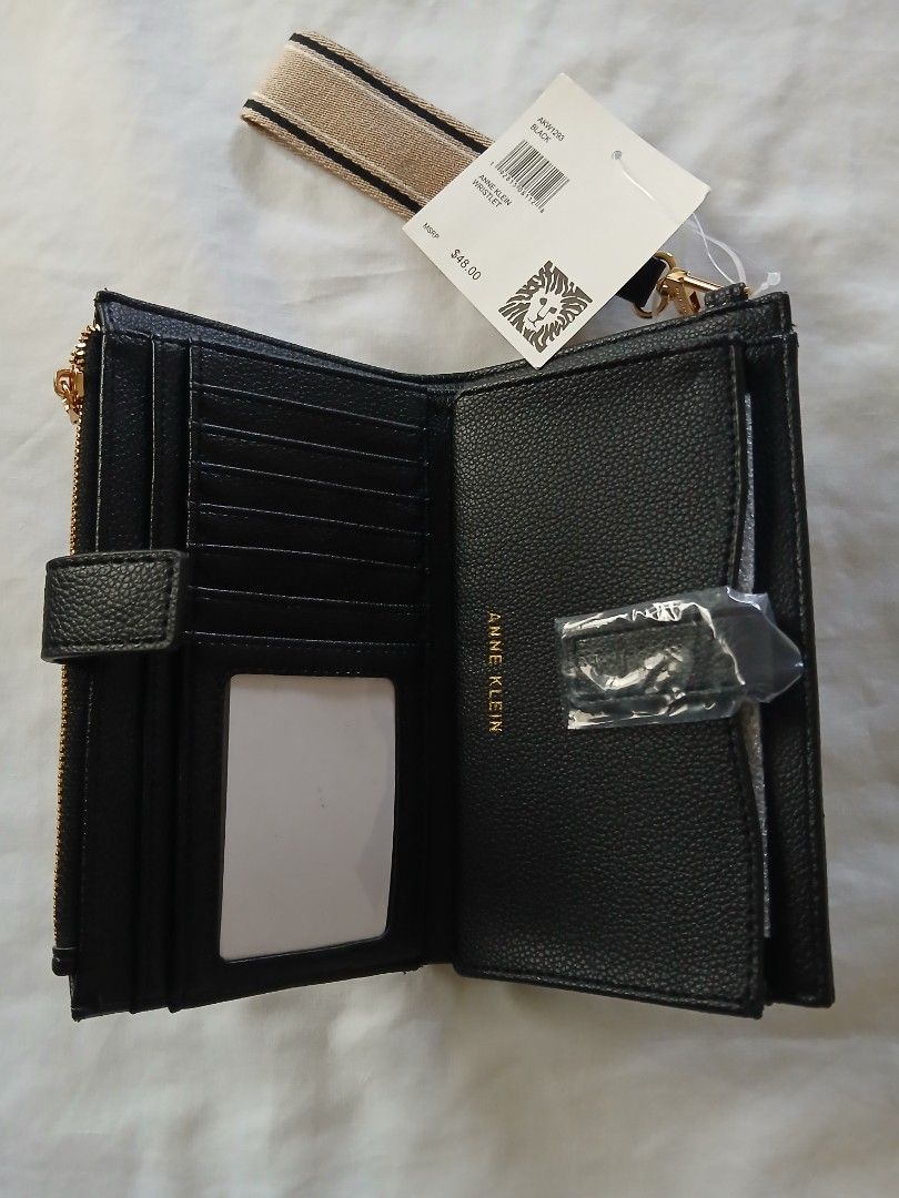 Anne Klein Black Wristlet Wallet with Strap (Category: Wallets & Card holders) located in Cavite. Submitted by gb1974 (Listing ID 1464379257, Image 3). Description: - BRAND NEW FRESH FROM THE USA!!! - Black Anne Klein wristlet - Front zip pocket - Snap closure - Multiple interior card slots - Clear ID window - Detachable strap - Original tag included (MSRP $48.00) - Ideal for organizing essentials.