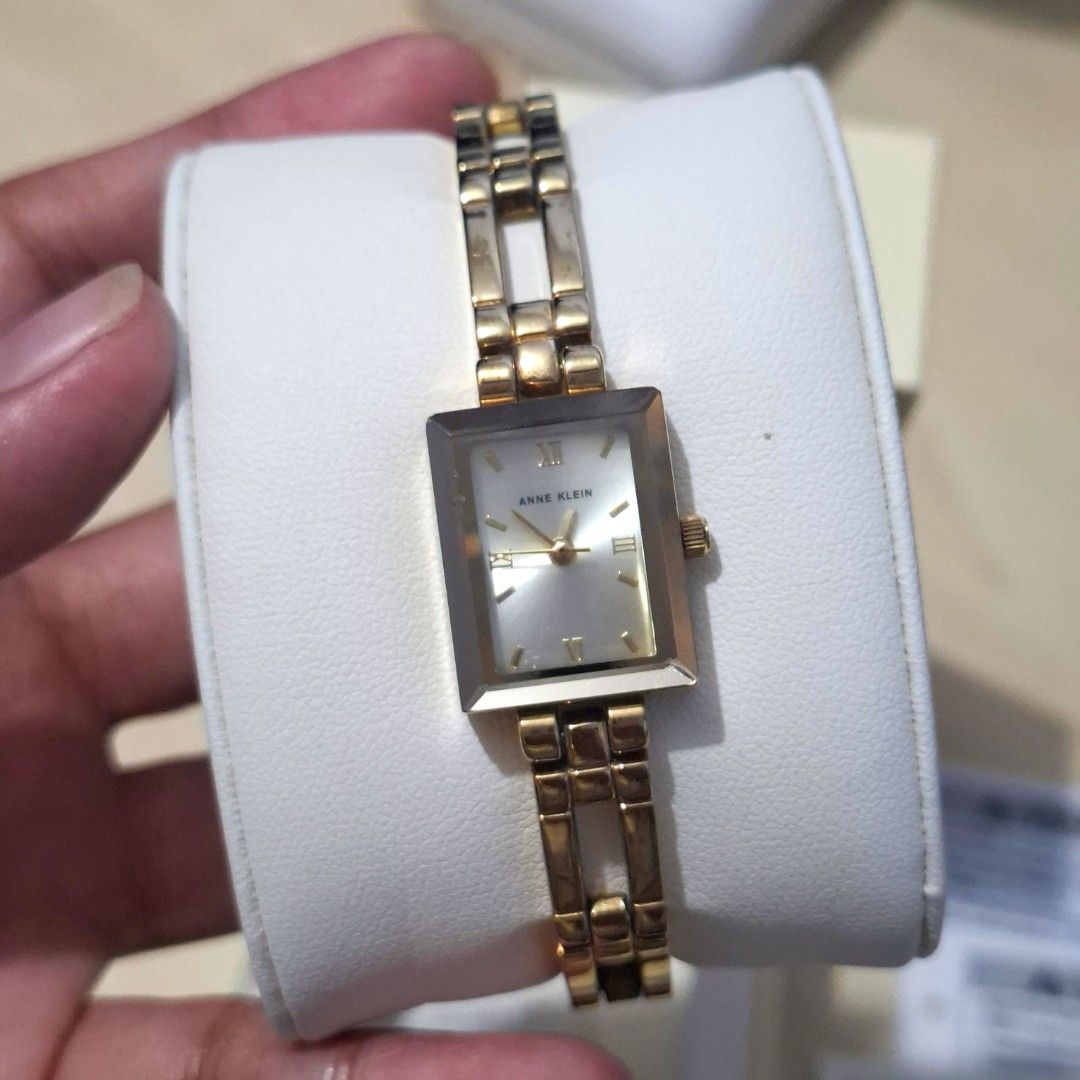 Anne Klein Gold Rectangle Watch with Box (Category: Women's Watches) located in Quezon City. Submitted by an.marie (Listing ID 1464405893, Image 3). Description: Anne Klein original bought last year, looks new Anne Klein 104899SVTT In Gold watch with rectangular sunray dial and Roman numeral and stick markers 16 mm metal case with mineral dial window Quartz movement with analog display Metal band with bangle bracelet clasp Water resistant to 30 m