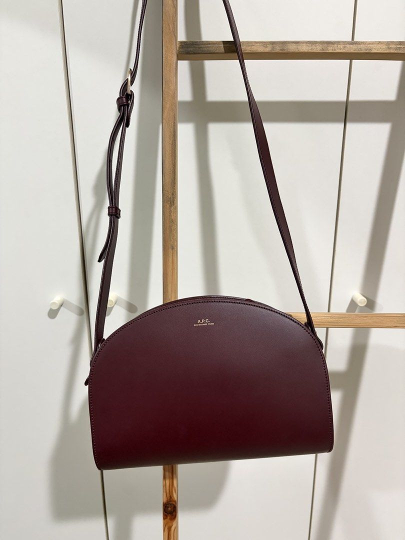 A.P.C. Demi-Lune Bag Vino (Category: Luxury Bags & Wallets) located in Pasig City. Submitted by bncln (Listing ID 1464456774, Image 1). Description: My first luxury bag (if it’s considered as luxury haha). Bought from a Korea pasabuy (💯 legit) at a really good price back then. Includes A.P.C. dust bag and authenticty certificate. Distinct shape and really gorgeous color 🤩 Only has 1 scratch but not noticeable. Perfect accessory to pull an outfi