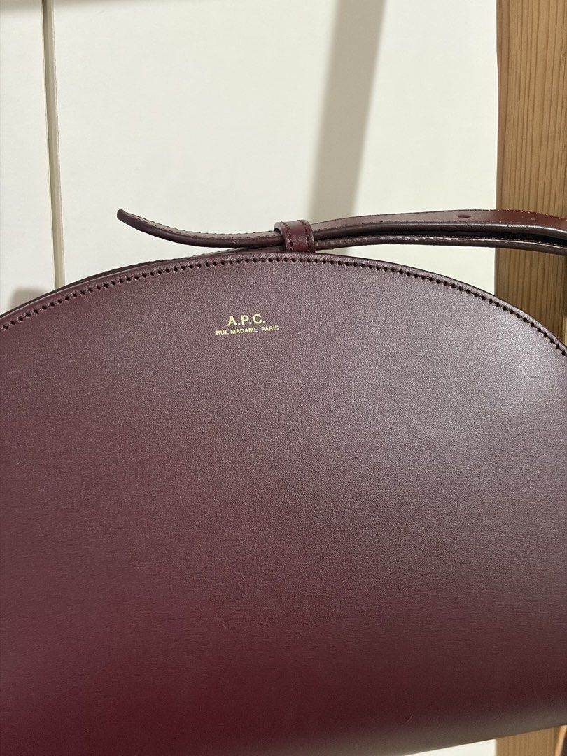 A.P.C. Demi-Lune Bag Vino (Category: Luxury Bags & Wallets) located in Pasig City. Submitted by bncln (Listing ID 1464456774, Image 3). Description: My first luxury bag (if it’s considered as luxury haha). Bought from a Korea pasabuy (💯 legit) at a really good price back then. Includes A.P.C. dust bag and authenticty certificate. Distinct shape and really gorgeous color 🤩 Only has 1 scratch but not noticeable. Perfect accessory to pull an outfi