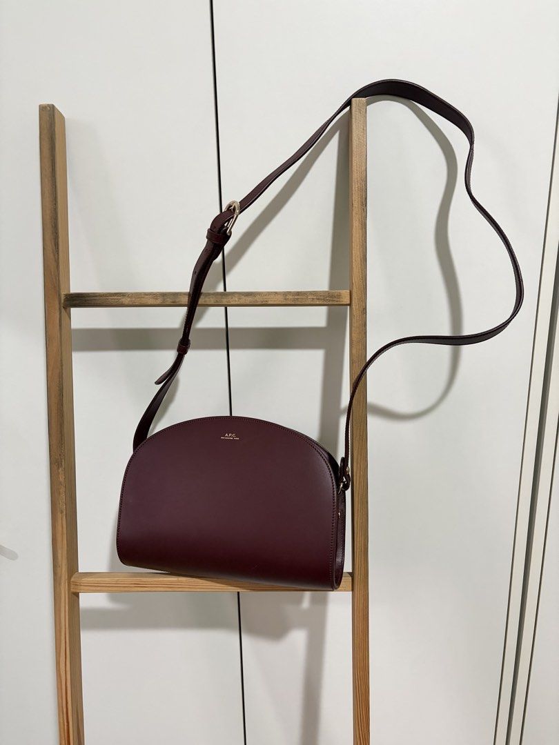 A.P.C. Demi-Lune Bag Vino (Category: Luxury Bags & Wallets) located in Pasig City. Submitted by bncln (Listing ID 1464456774, Image 2). Description: My first luxury bag (if it’s considered as luxury haha). Bought from a Korea pasabuy (💯 legit) at a really good price back then. Includes A.P.C. dust bag and authenticty certificate. Distinct shape and really gorgeous color 🤩 Only has 1 scratch but not noticeable. Perfect accessory to pull an outfi