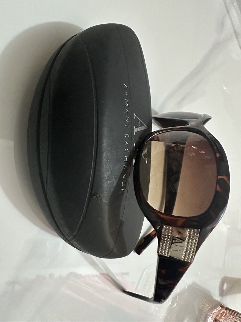 Armani Exchange Sunglasses with Case (Category: Sunglasses & Eyewear) located in Antipolo. Submitted by ririwearph (Listing ID 1464412709, Image 3). Description: - Authentic Armani Exchange sunglasses - Stylish tortoiseshell pattern on frames - Embellished arms with sparkling rhinestones and AX logo - Comes with original hard case - Ideal for sunny weather and adding a touch of glam.
