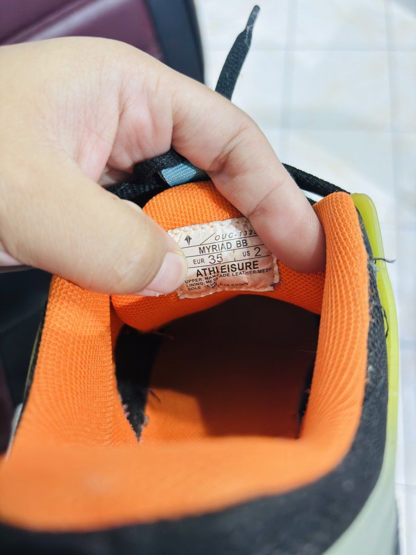 Athleisure Myriad BB Athletic Shoes (Category: Casual Shoes) located in Manila. Submitted by purpleliciousss (Listing ID 1464383556, Image 3). Description: - Stylish black and orange athletic shoes - Size: EUR 35 / US 2 - Features a breathable mesh upper with synthetic overlays - Comfortable for everyday wear and light workouts - Ideal for achieving a casual and sporty look.