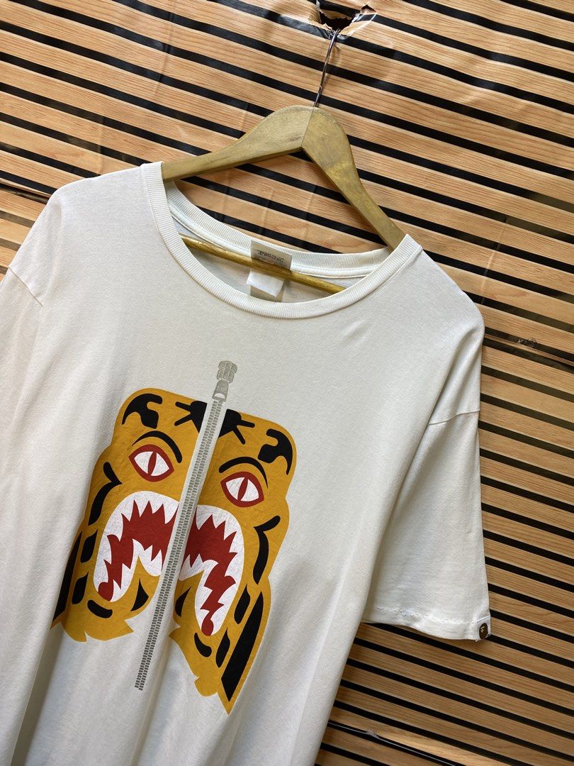 Authentic A Bathing Ape (BAPE) Colors Tiger Tee (Category: Tshirts & Polo Shirts ) located in Makati City. Submitted by drip.poww (Listing ID 1464537408, Image 3). Description: - Authentic Bape - Color: White - Size: XL - Dimes: 24x29 - Authentic - Excellent condition - Need wash, fresh from bale - Material: 100% Cotton Please don’t expect too much—these are thrifted (ukay) items. 😊 !!STILL NEGOTIABLE!!.