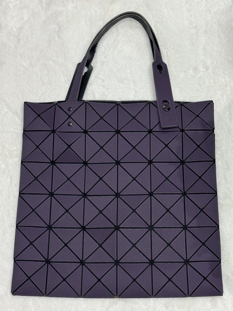 Authentic Bao Bao Issey Miyake Tote Bag (Category: Tote Bags) located in San Nicolas. Submitted by ihascat (Listing ID 1464515182, Image 1). Description: - Cool purple tote bag with a chic geometric pattern. - Features black straps with a stylish sheen. - Ideal size for everyday essentials. - Secure zipper closure for peace of mind. - Modern and fashionable design..