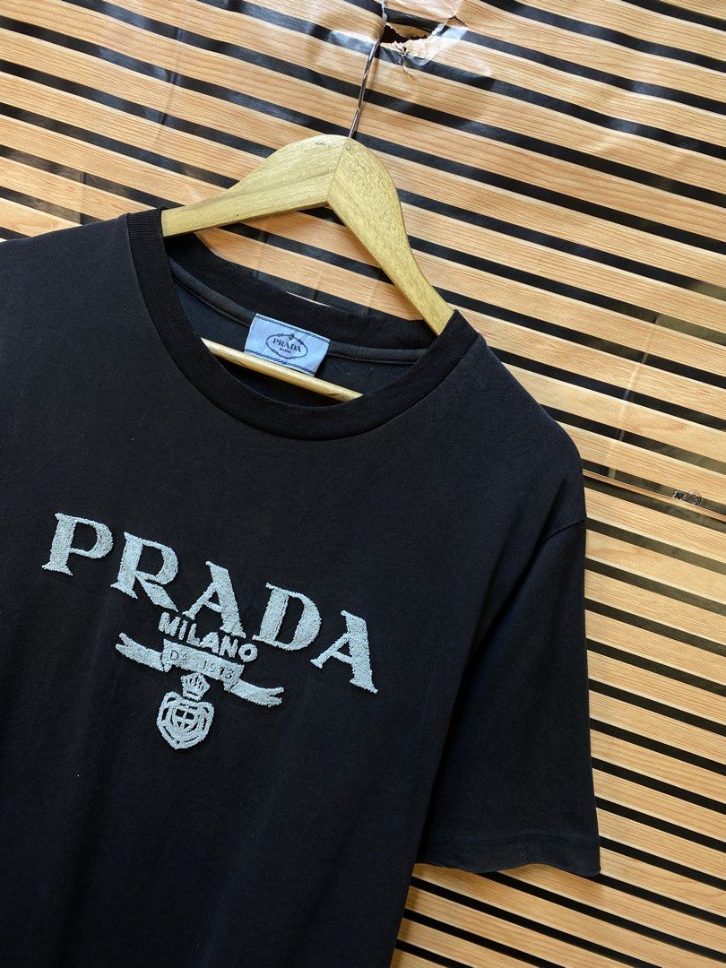 AUTHENTIC PRADA MILANO TEE (Category: Tshirts & Polo Shirts ) located in Makati City. Submitted by drip.poww (Listing ID 1464537058, Image 2). Description: - Authentic Prada - Color: Black - Size: Meduim to large - Dimes: 22x28 - Authentic - Excellent condition - Need wash, fresh from bale - Material: 100% Cotton Please don’t expect too much—these are thrifted (ukay) items. 😊 !!STILL NEGOTIABLE!!.