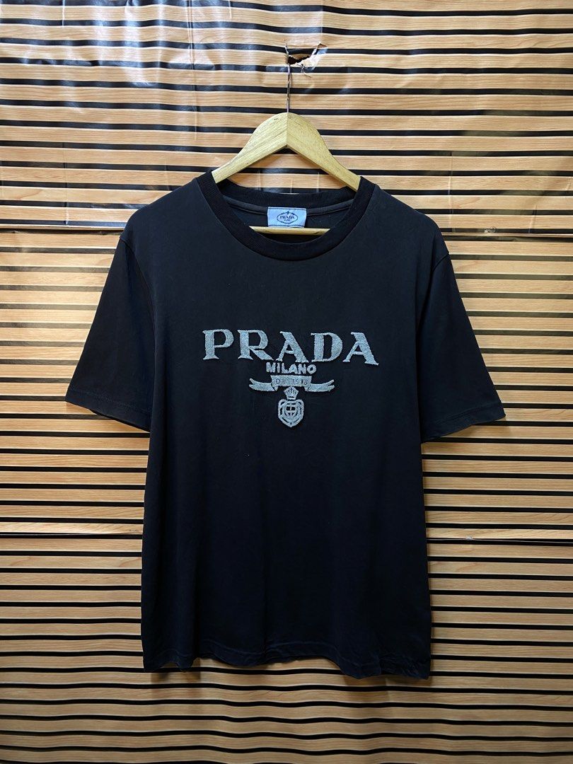 AUTHENTIC PRADA MILANO TEE (Category: Tshirts & Polo Shirts ) located in Makati City. Submitted by drip.poww (Listing ID 1464537058, Image 1). Description: - Authentic Prada - Color: Black - Size: Meduim to large - Dimes: 22x28 - Authentic - Excellent condition - Need wash, fresh from bale - Material: 100% Cotton Please don’t expect too much—these are thrifted (ukay) items. 😊 !!STILL NEGOTIABLE!!.