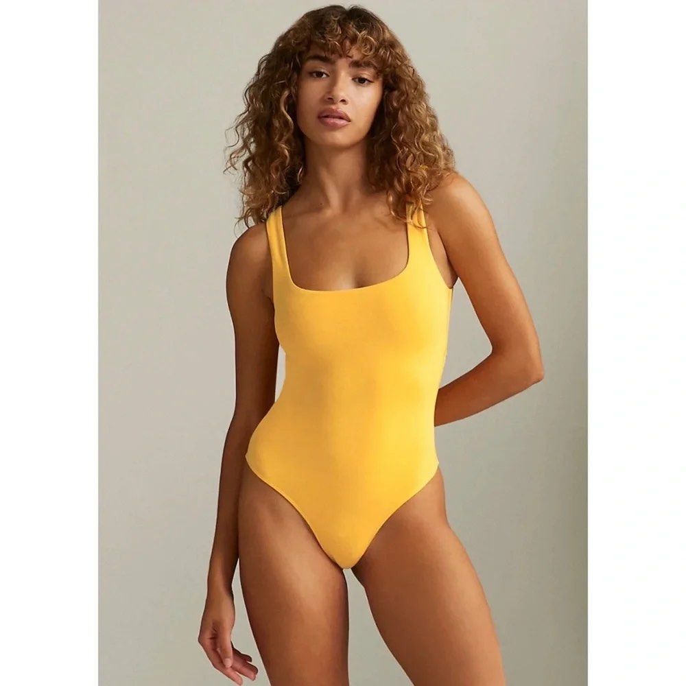 Babaton Yellow Square Neck Bodysuit XS (Category: Sleeveless) located in Malabon City. Submitted by lheithriftshop (Listing ID 1464434941, Image 1). Description: - Yellow square neck bodysuit - Brand: Babaton - Size: XS - Thong bottom - Stretchy material - Versatile: great for layering or wearing on its own - Pairs well with jeans or skirts.