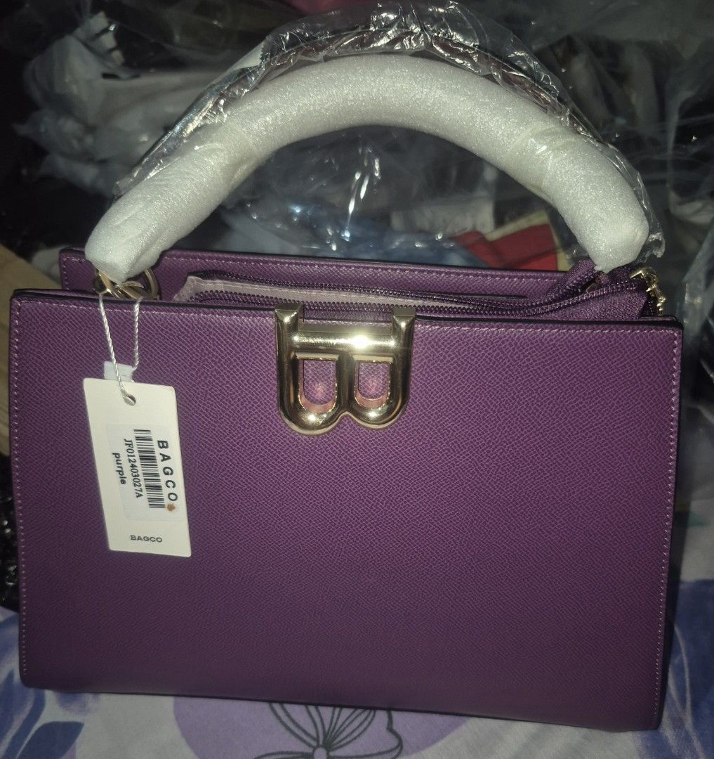 BAGCO Top Handle Bag with Sling (Category: Shoulder Bags) located in Manila. Submitted by vsballeras1984 (Listing ID 1464501496, Image 2). Description: - Structured purple handbag from BAGCO - Includes matching wallet - Detachable sling strap for versatile wear - Elegant gold hardware details - White protective wrap on top handle - Brand new with tag still attached.