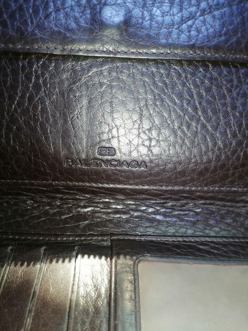 Balenciaga Brown Leather Zip Around Wallet (Category: Luxury Bags & Wallets) located in Digos. Submitted by crodualady82694 (Listing ID 1464568442, Image 2). Description: - Balenciaga brown leather zip-around wallet. - Features a sophisticated textured leather finish. - Ample card slots and internal compartments for organization. - Secure zippered section for coins or small items. - Comes with a detachable wrist strap for easy carrying. - Ideal f