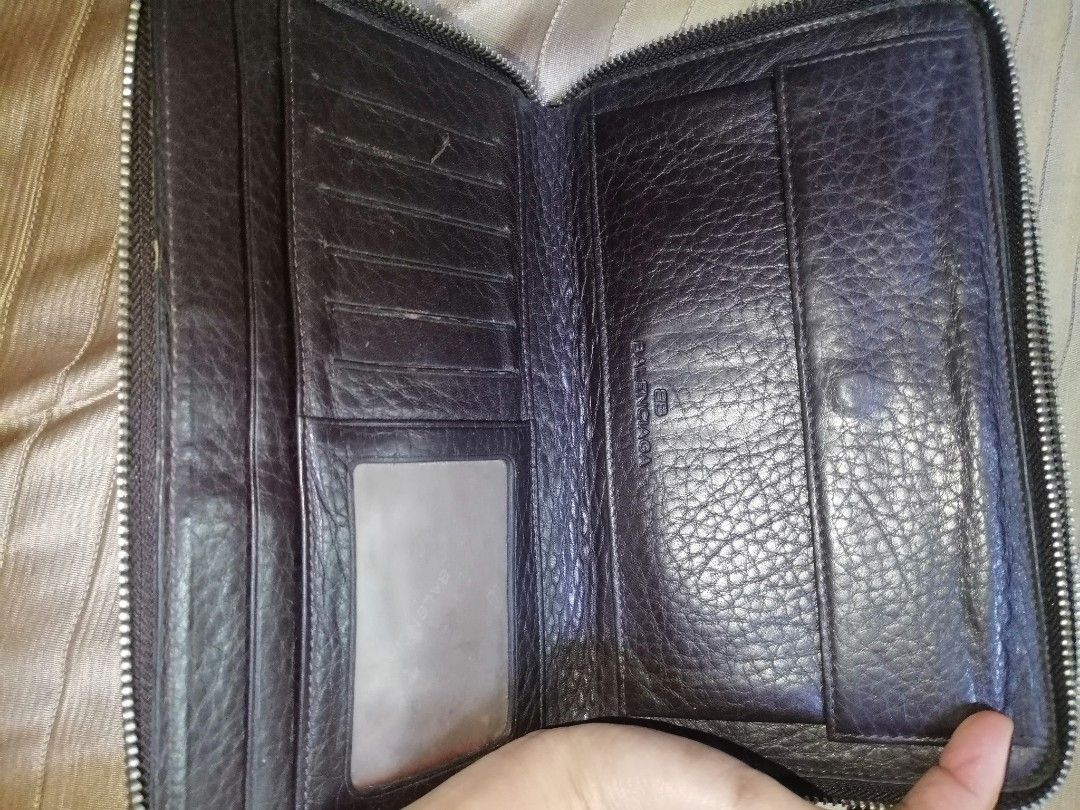 Balenciaga Brown Leather Zip Around Wallet (Category: Luxury Bags & Wallets) located in Digos. Submitted by crodualady82694 (Listing ID 1464568442, Image 3). Description: - Balenciaga brown leather zip-around wallet. - Features a sophisticated textured leather finish. - Ample card slots and internal compartments for organization. - Secure zippered section for coins or small items. - Comes with a detachable wrist strap for easy carrying. - Ideal f