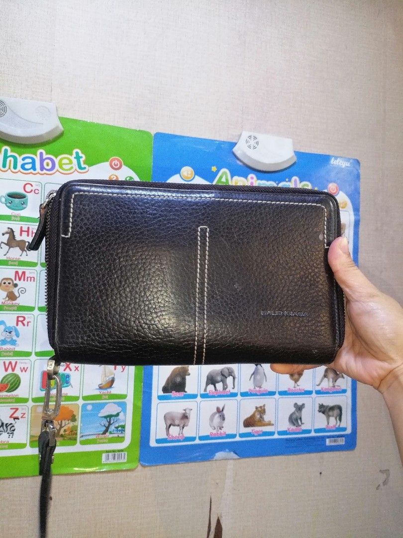 Balenciaga Brown Leather Zip Around Wallet (Category: Luxury Bags & Wallets) located in Digos. Submitted by crodualady82694 (Listing ID 1464568442, Image 1). Description: - Balenciaga brown leather zip-around wallet. - Features a sophisticated textured leather finish. - Ample card slots and internal compartments for organization. - Secure zippered section for coins or small items. - Comes with a detachable wrist strap for easy carrying. - Ideal f