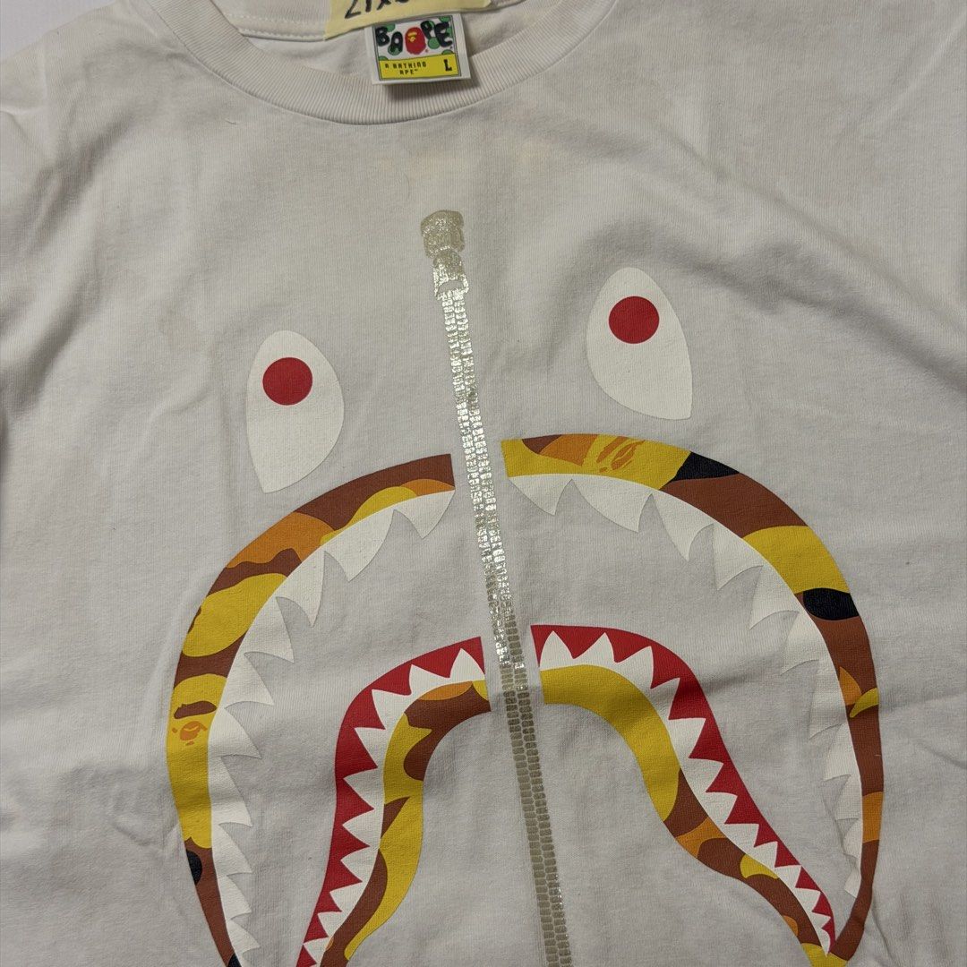 BAPE Shark Face Zip Tee White (Category: Tshirts & Polo Shirts ) located in Manila. Submitted by johnedel_james (Listing ID 1464537639, Image 2). Description: - Classic BAPE t-shirt - Iconic shark face graphic with zip detail - White cotton fabric - Tagged size L - Perfect for streetwear enthusiasts.