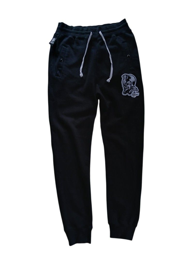 Bape ursus x izzue(authentic) (Category: Joggers) located in San Jose. Submitted by garments17 (Listing ID 1464381041, Image 1). Description: - Brand: IZZY USS ARMY - Color: Black - Size: S - Features: Skull patch on left leg, 'IZ-USS-ARMY' graphic on back pockets, drawstring waist - Origin: Made in China.