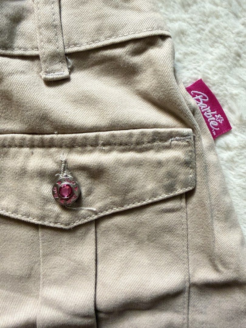 Barbie Cargo Skirt kids (Category: Skirts) located in Tagaytay City. Submitted by melissamm0237 (Listing ID 1464400638, Image 3). Description: - Cute tan cargo skirt from Barbie World. - Features embroidered flowers and 'Barbie World' text. - Convenient pocket on the right side. - Comfortable elastic waistband at the back. - Ideal for casual wear. - Tag size: 10 years..